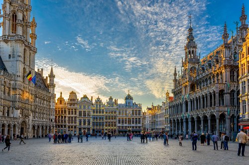 View of the Grand Place in Brussels with historic buildings and people visiting the square.