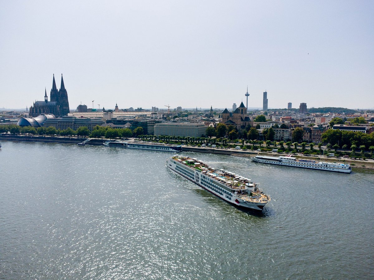 The A-ROSA SENA sails on the Rhine, with the skyline of Cologne and the Cologne Cathedral in the background.